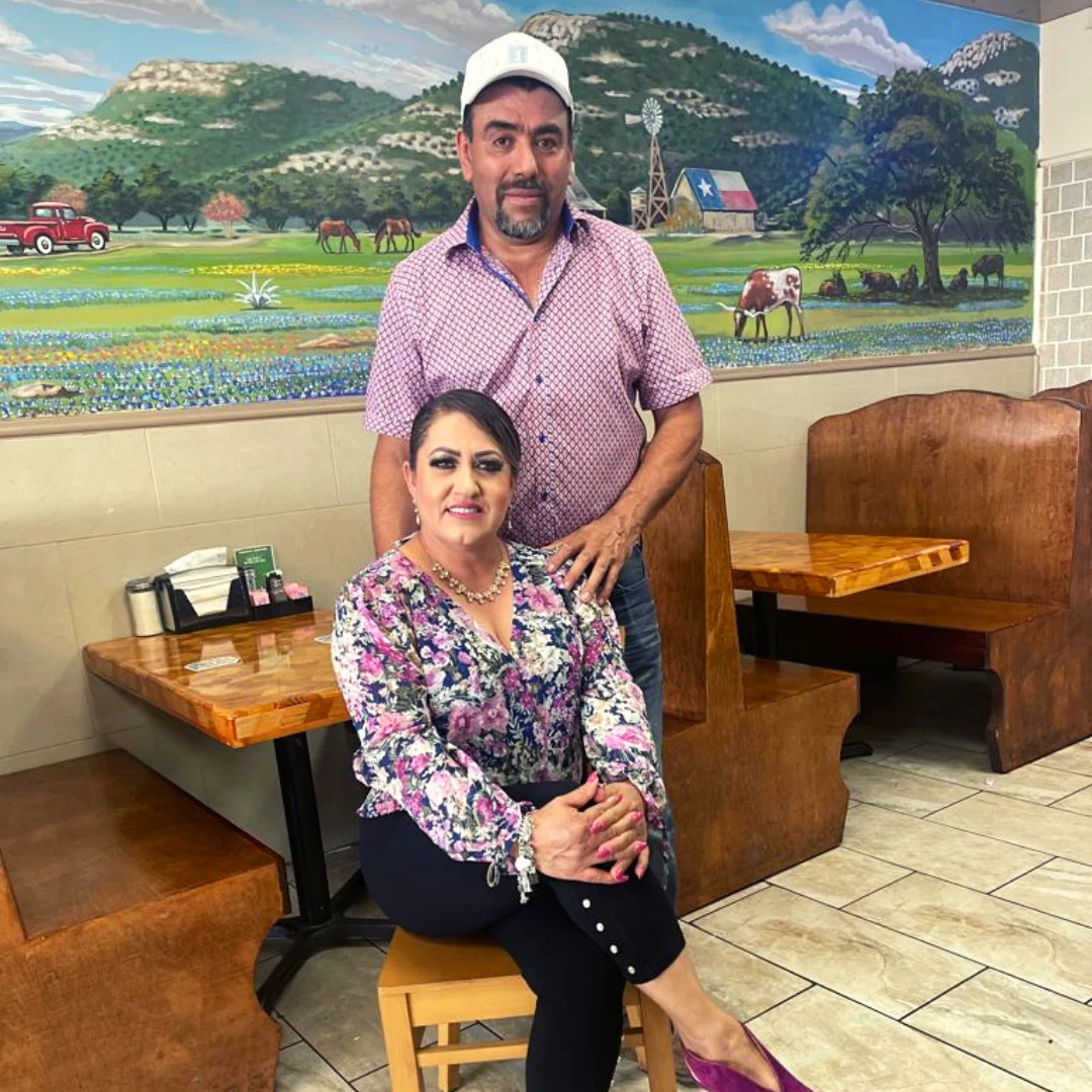 Gerardo Aguirre and Ana Gloria Fernandez in their restaurant, in front of a hand-painted Texas Hill Country mural